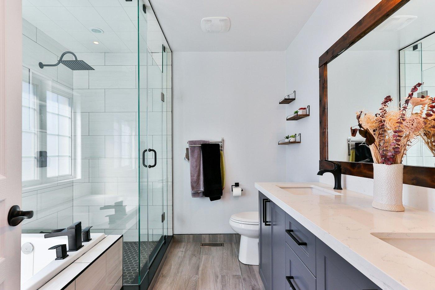 Renovated bathroom with frameless shower and timber vanity
